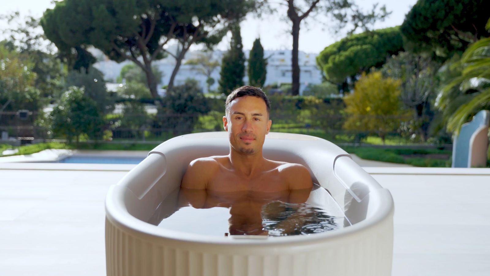 Still from the film: Jonathan Ramalho in an ice bath beside a pool