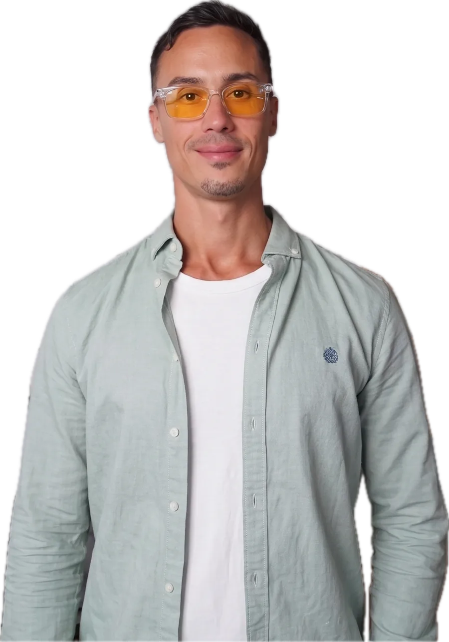 Jonathan Ramalho in a light green shirt, white T-shirt and amber-tinted glasses, smiling.